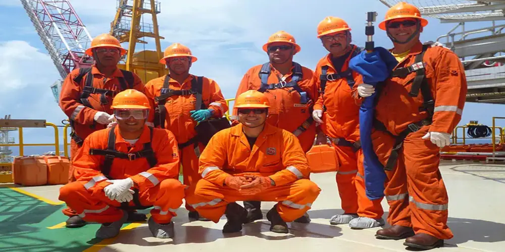S-TRADIX offshore crew in safety gear on a platform deck
