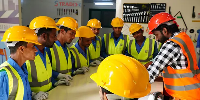 Technicians in hard hats during a safety briefing